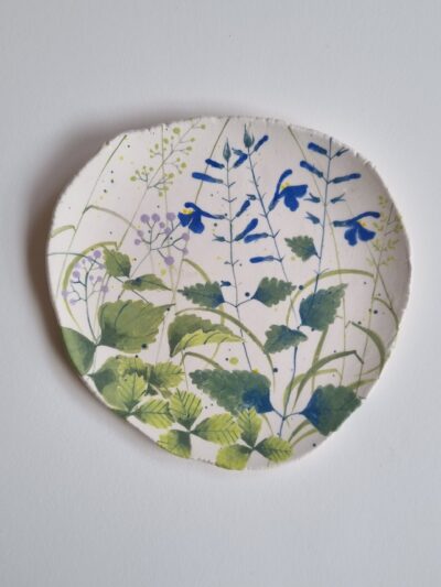 Sarah's garden platter Coloured underglazes on midfire white clay> Slab form. midfire. Clear glaze. Has attached hanging device
