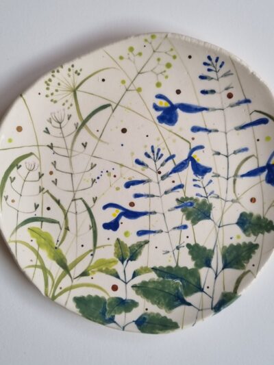 Sarah's garden platter Coloured underglazes on midfire white clay. Slab form. white earthenware. Gold lustre. Clear glaze. Has attached hanging device
