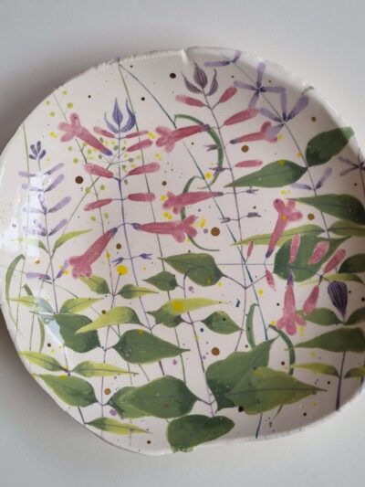 Sarah's garden platter Coloured underglazes on white earthenware. Slab form platter. Gold lustre. Clear glaze. Has attached hanging device