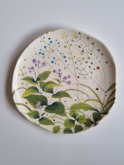 Sarah's garden platter Coloured underglazes on white earthenware. Slab form platter. Gold lustre. Clear glaze. Has attached hanging device