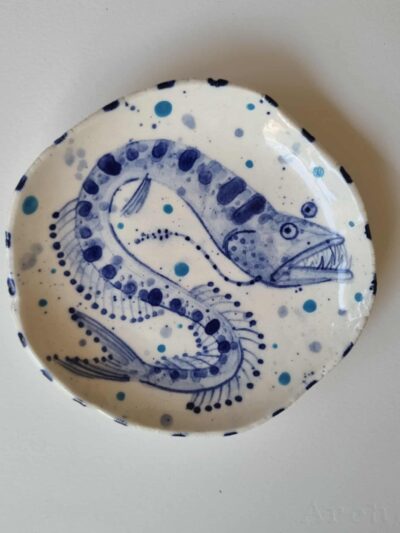 Fish platter. Cobalt oxide and coloured underglazes on midfire white clay. Slab form. Clear glaze. Has attached hanging device.